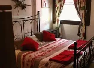 Camera da letto con letto matrimoniale, letto a castello e grande finestra