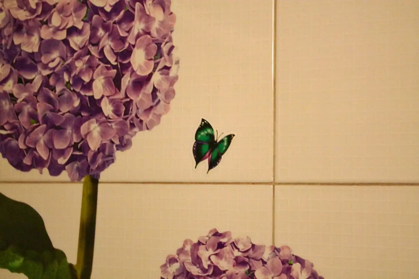 Dettaglio della decorazione a decoupage di fiori sul muro del bagno