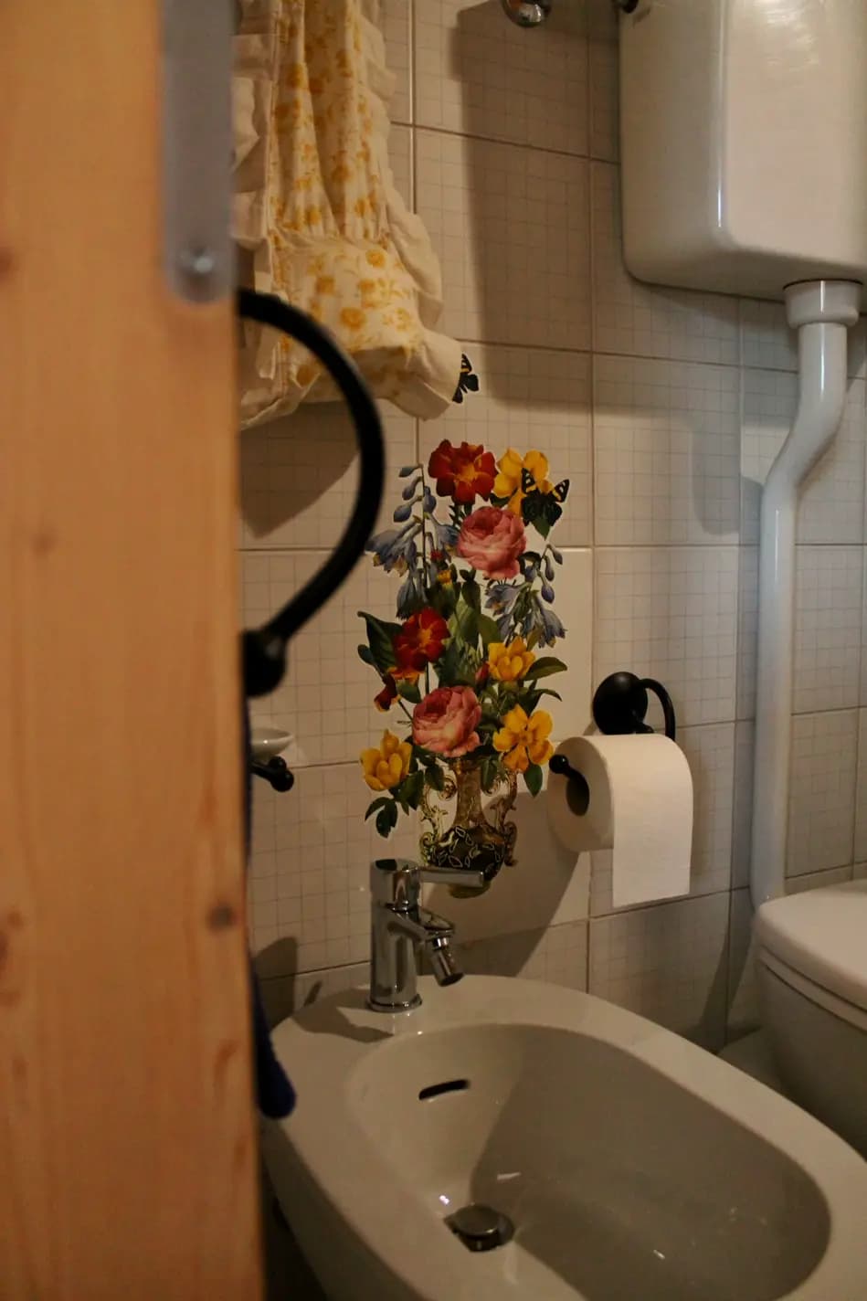 Bidet con sopra un decoupage di fiori applicato sul muro